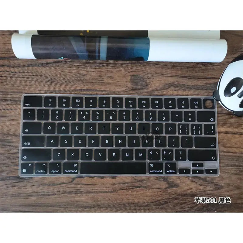 MacBook Pro 16 screen film High-definition Screen Film keyboard accessory on a wooden surface with a mouse and rolled up poster.