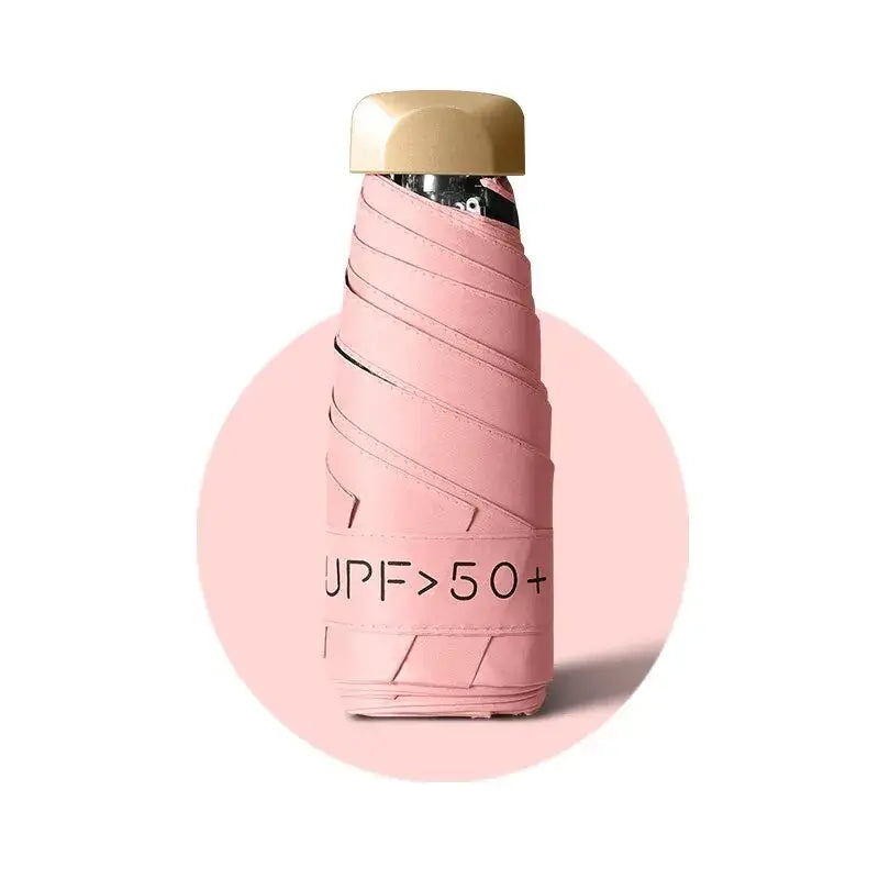 UV protection women’s umbrella, stylish compact design, pink color with UPF 50+ label, perfect for sun protection.