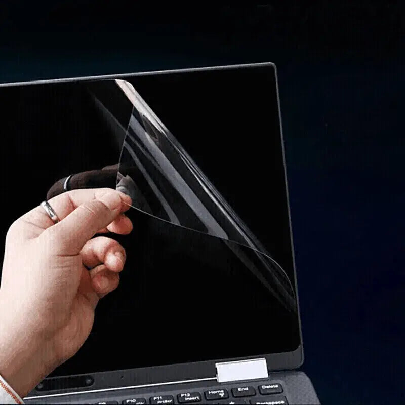 Hand lifting the MacBook Pro 16 screen film High-definition Screen Film from the laptop screen.